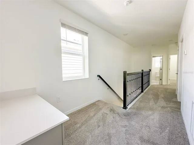 a view of a hallway with staircase