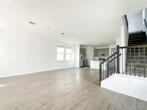 a view of main area and entryway with wooden floor