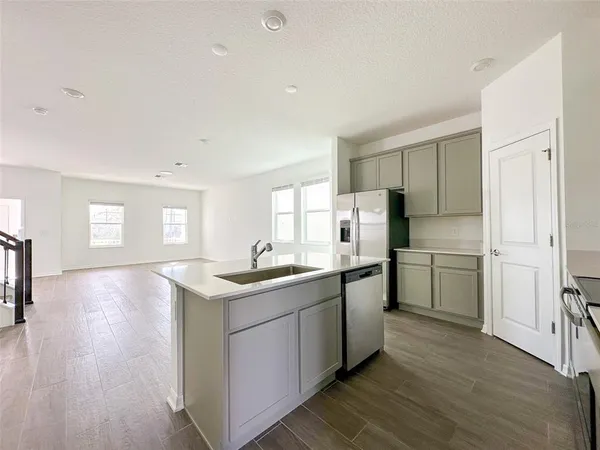 a kitchen with a sink stove and refrigerator