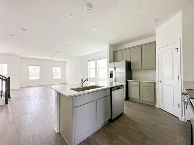 a kitchen with a sink stove and refrigerator