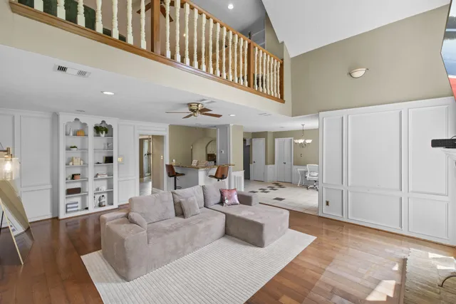 a living room with furniture and wooden floor