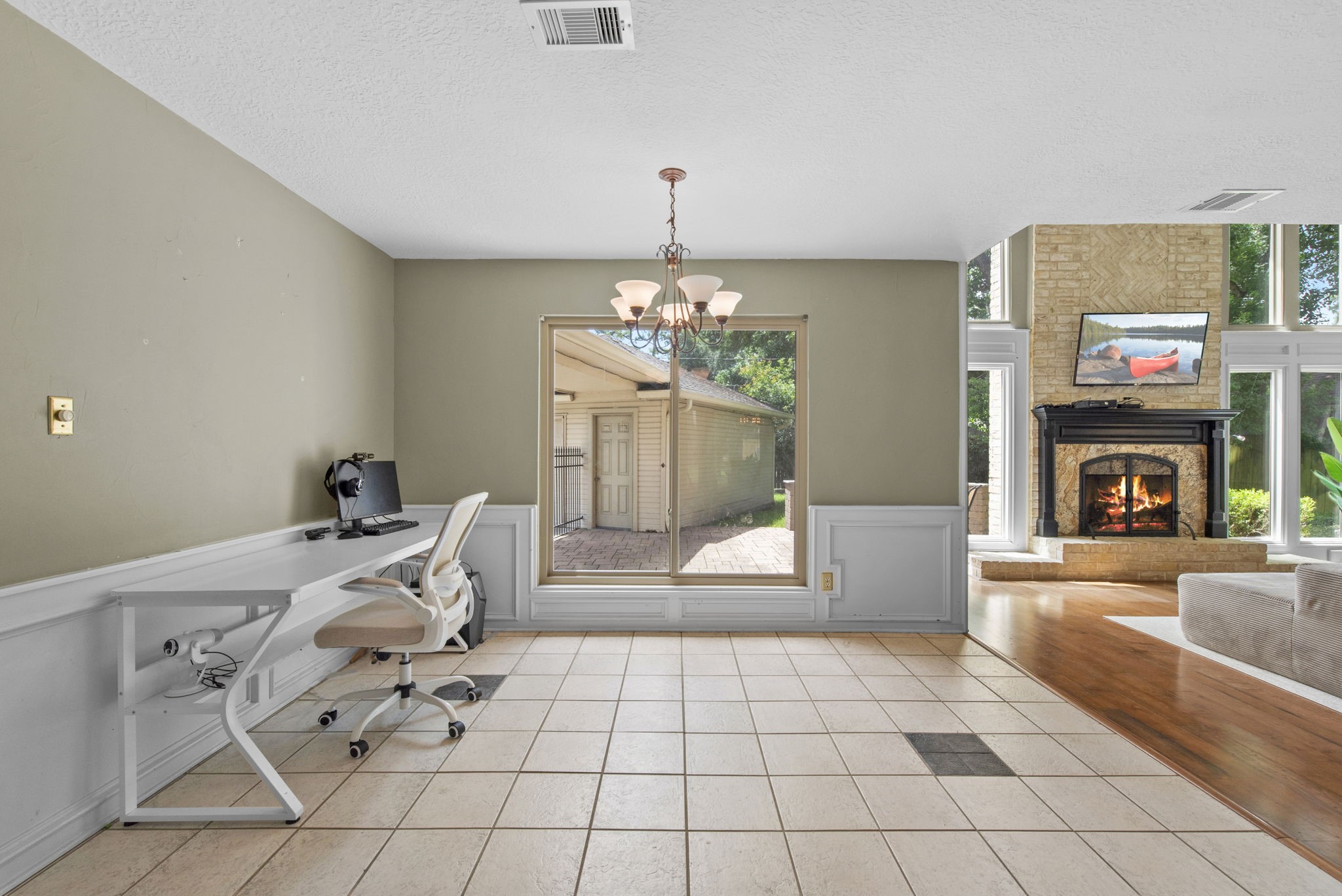 5507 Glenmere Lane Spring, TX 77379 - Photo 14 of 37 a living room with furniture a fireplace and a chandelier