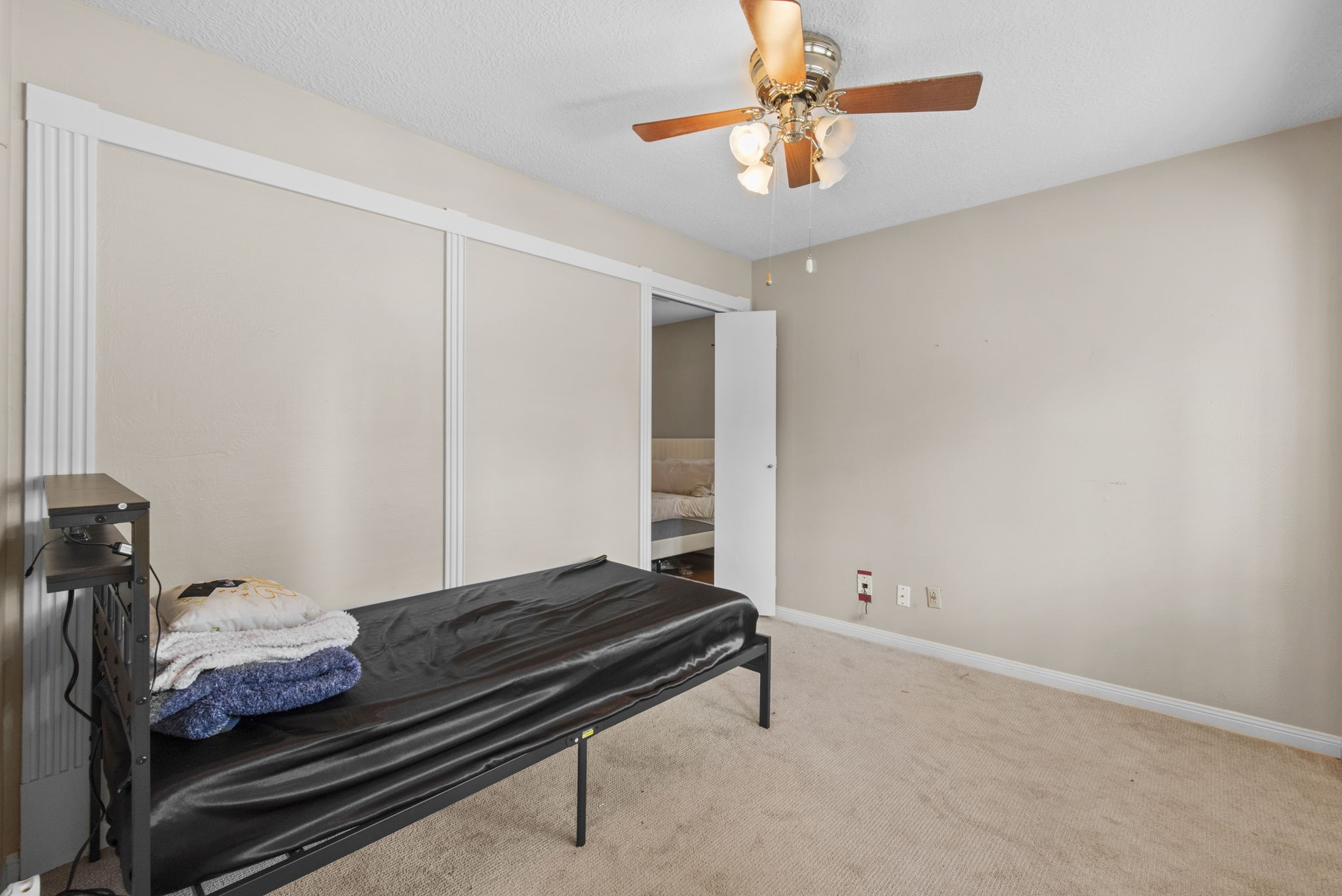 5507 Glenmere Lane Spring, TX 77379 - Photo 18 of 37 a bedroom with a bed and a chandelier