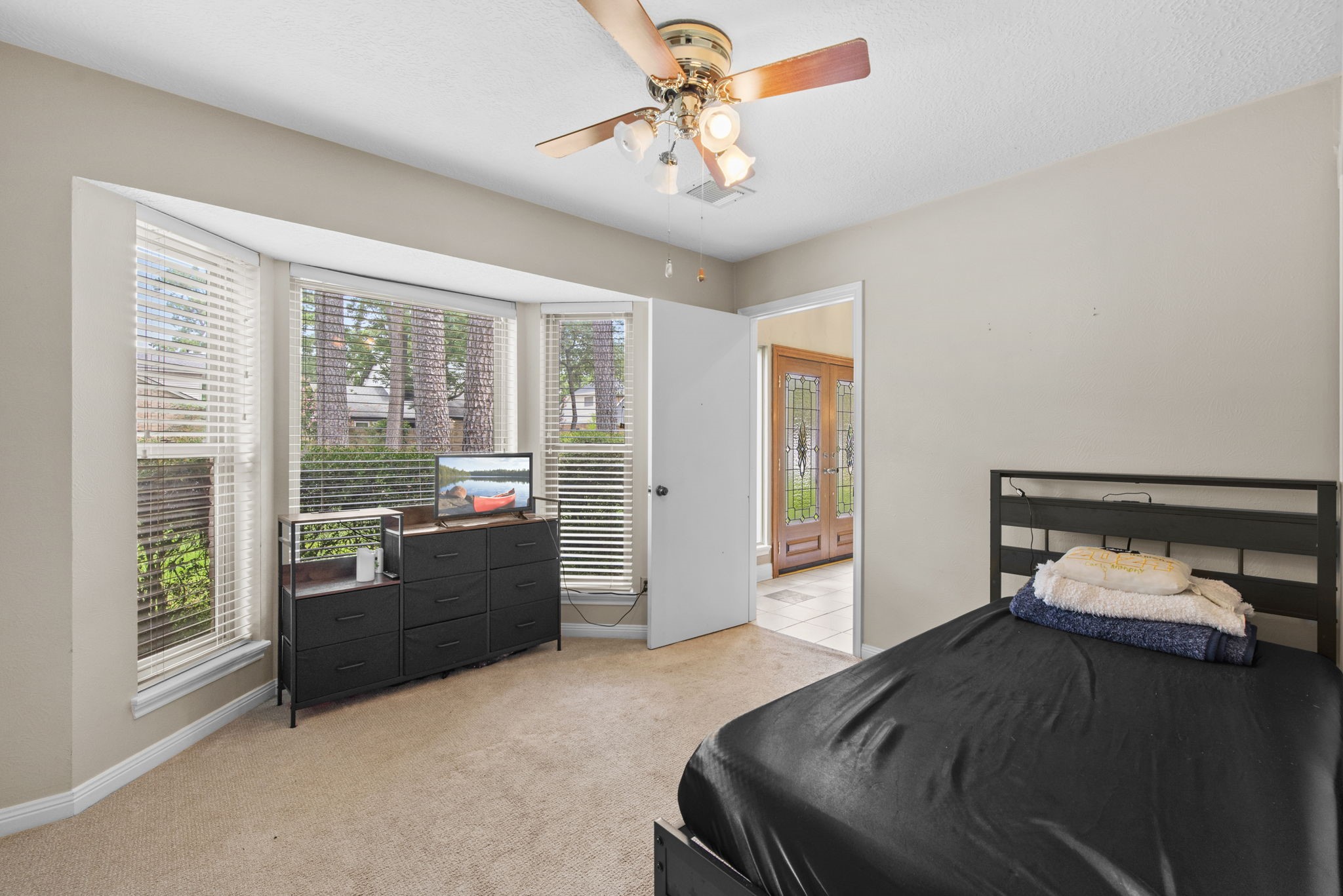 5507 Glenmere Lane Spring, TX 77379 - Photo 19 of 37 a bedroom with a bed and wooden floor