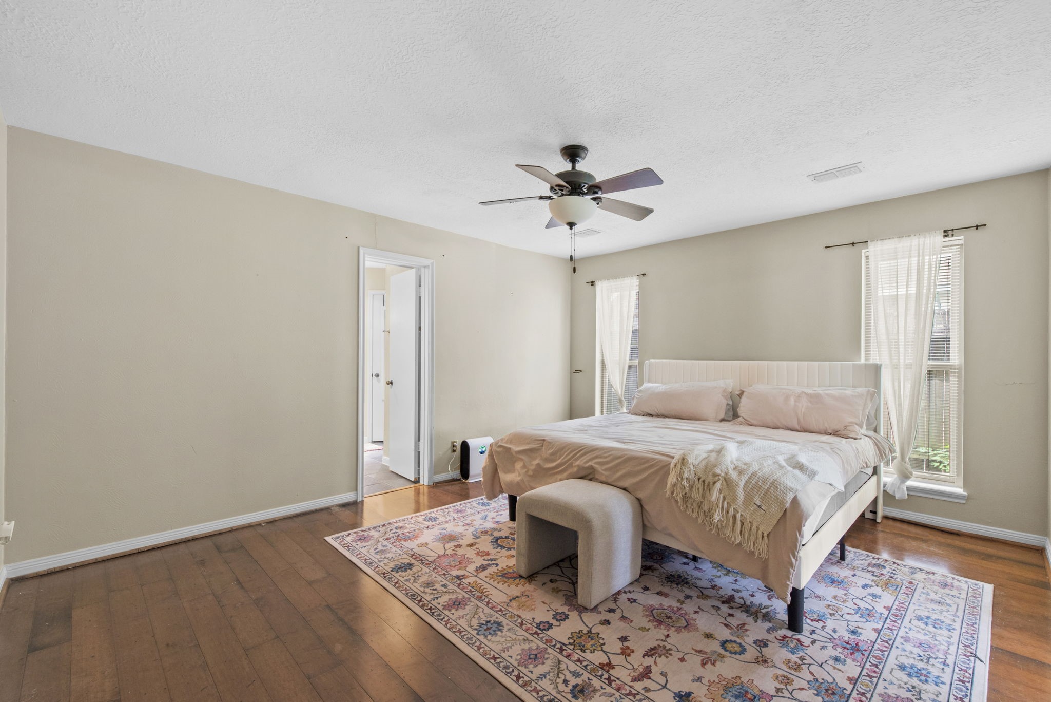 5507 Glenmere Lane Spring, TX 77379 - Photo 21 of 37 a bedroom with a bed and a chandelier