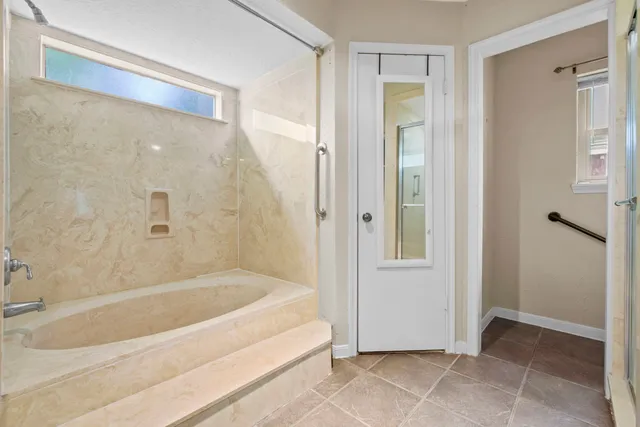 a bathroom with a bathtub and a shower