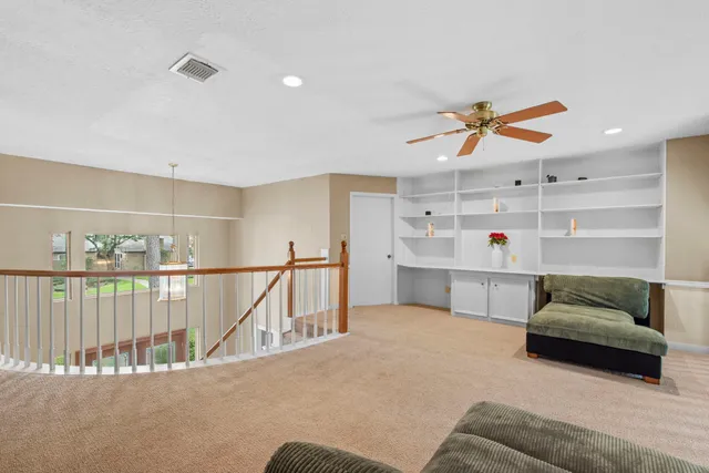 a living room with furniture and kitchen view
