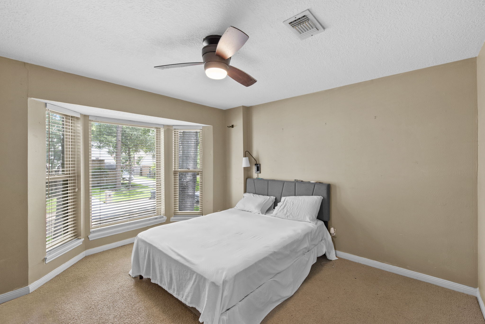 5507 Glenmere Lane Spring, TX 77379 - Photo 28 of 37 a bedroom with a large bed and a large window