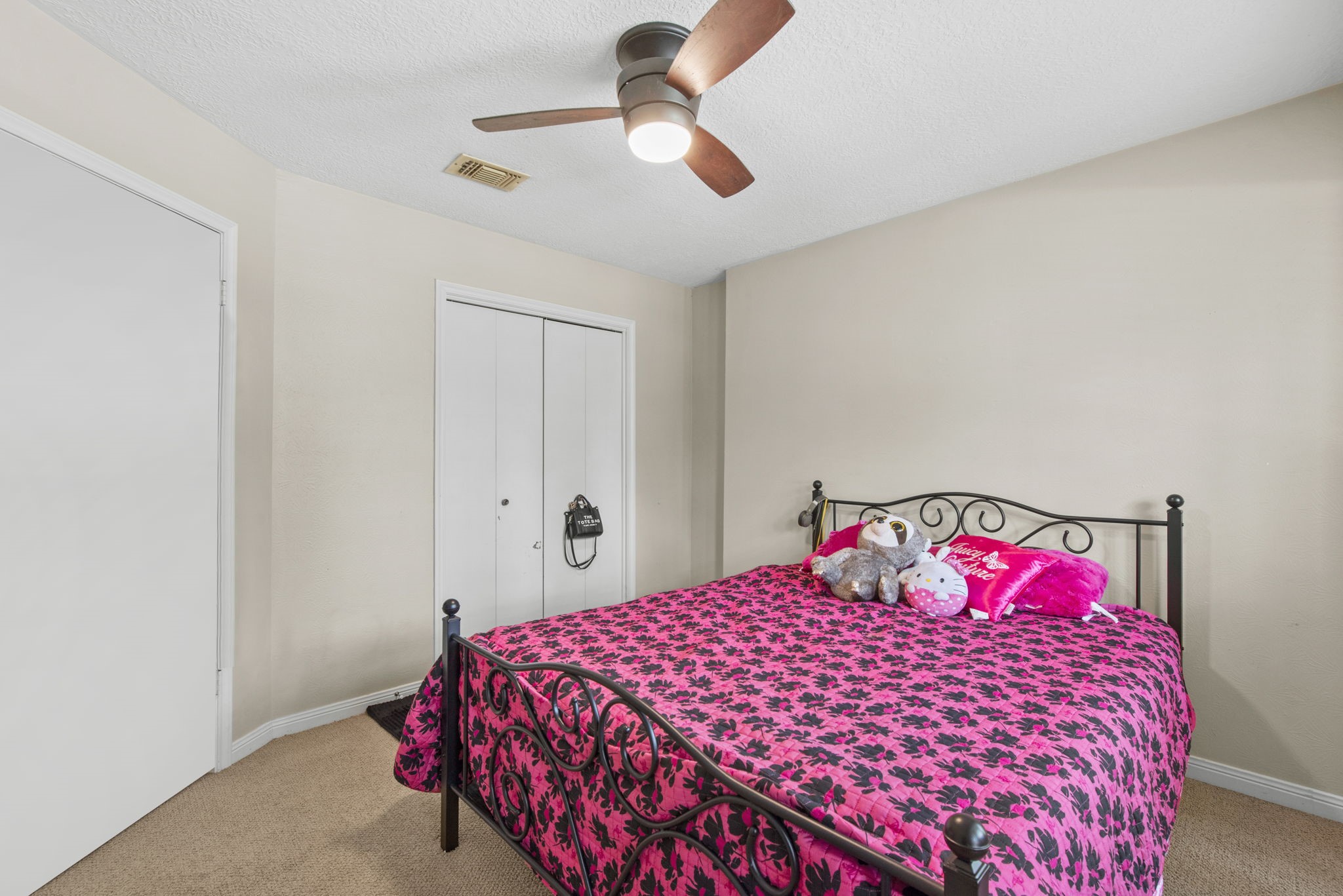 5507 Glenmere Lane Spring, TX 77379 - Photo 30 of 37 a bedroom with a bed and a chandelier