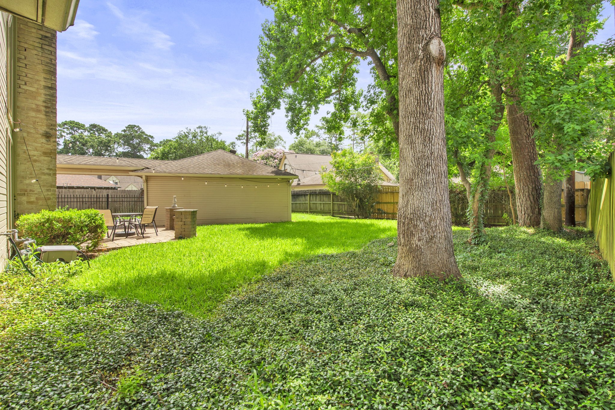 5507 Glenmere Lane Spring, TX 77379 - Photo 35 of 37 a view of a garden with a tree in the background