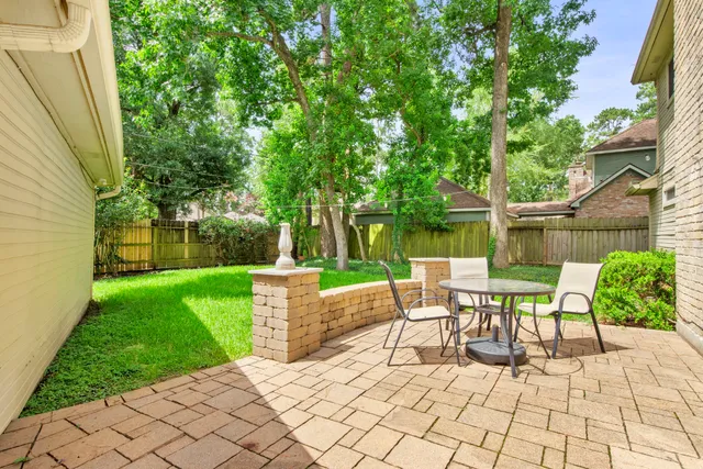 a view of a chairs and table in backyard of the house