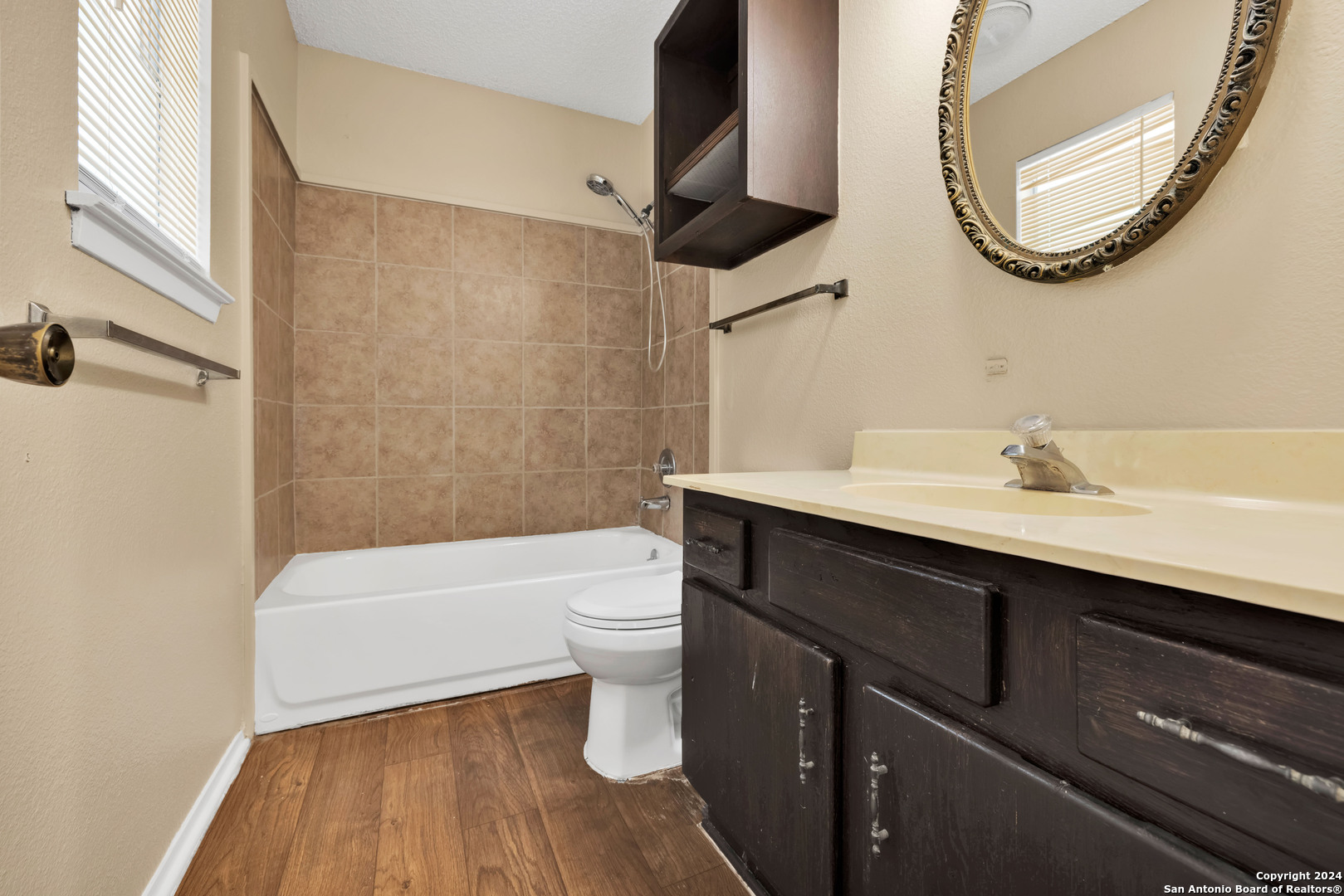 6427 Ridge Pl Street San Antonio, TX 78250 - Photo 11 of 14 a bathroom with a sink a toilet and a mirror