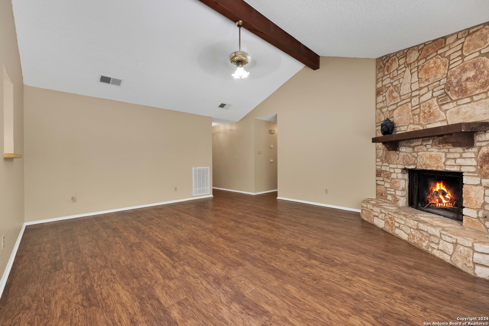 6427 Ridge Pl Street San Antonio, TX 78250 - Photo 3 of 14 a view of an empty room with wooden floor fireplace and a window