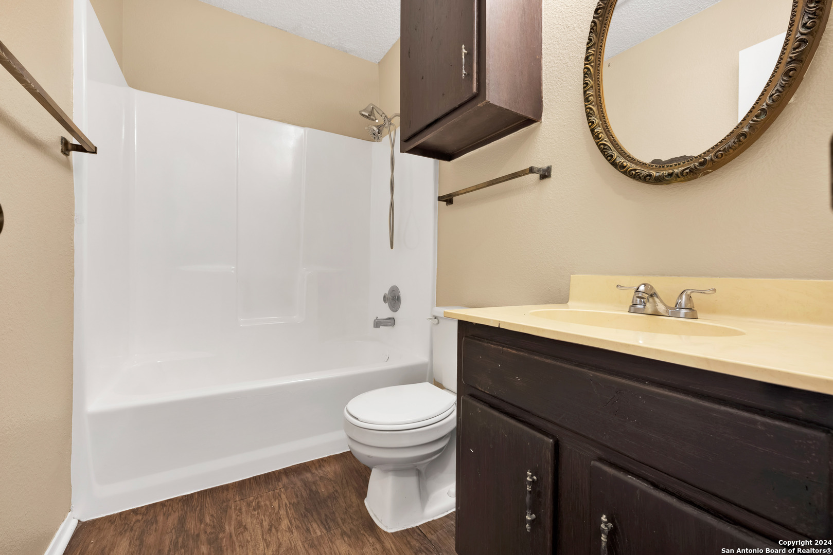 6427 Ridge Pl Street San Antonio, TX 78250 - Photo 8 of 14 a bathroom with a sink a toilet and a mirror