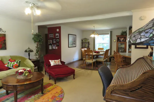 a living room with furniture and a dining table