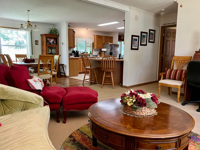 a view of a dining room with furniture a chandelier and wooden floor