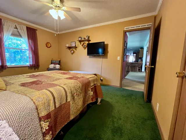a kitchen view with stainless steel appliances kitchen island granite countertop a refrigerator and a sink