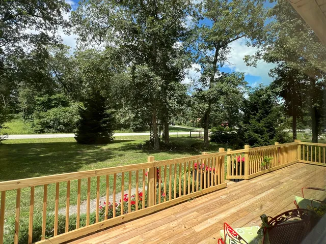 a front view of a house with a yard and garden