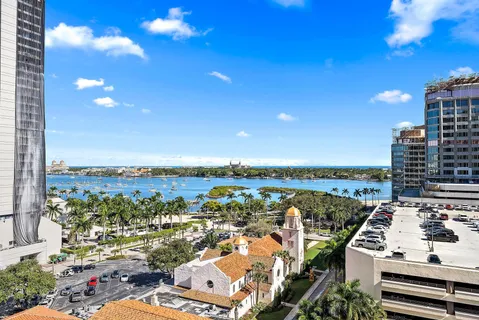 a view of a city from a balcony with furniture