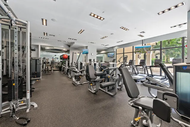 a living room with furniture and large windows