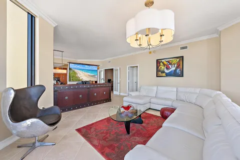 a living room with furniture and a floor to ceiling window