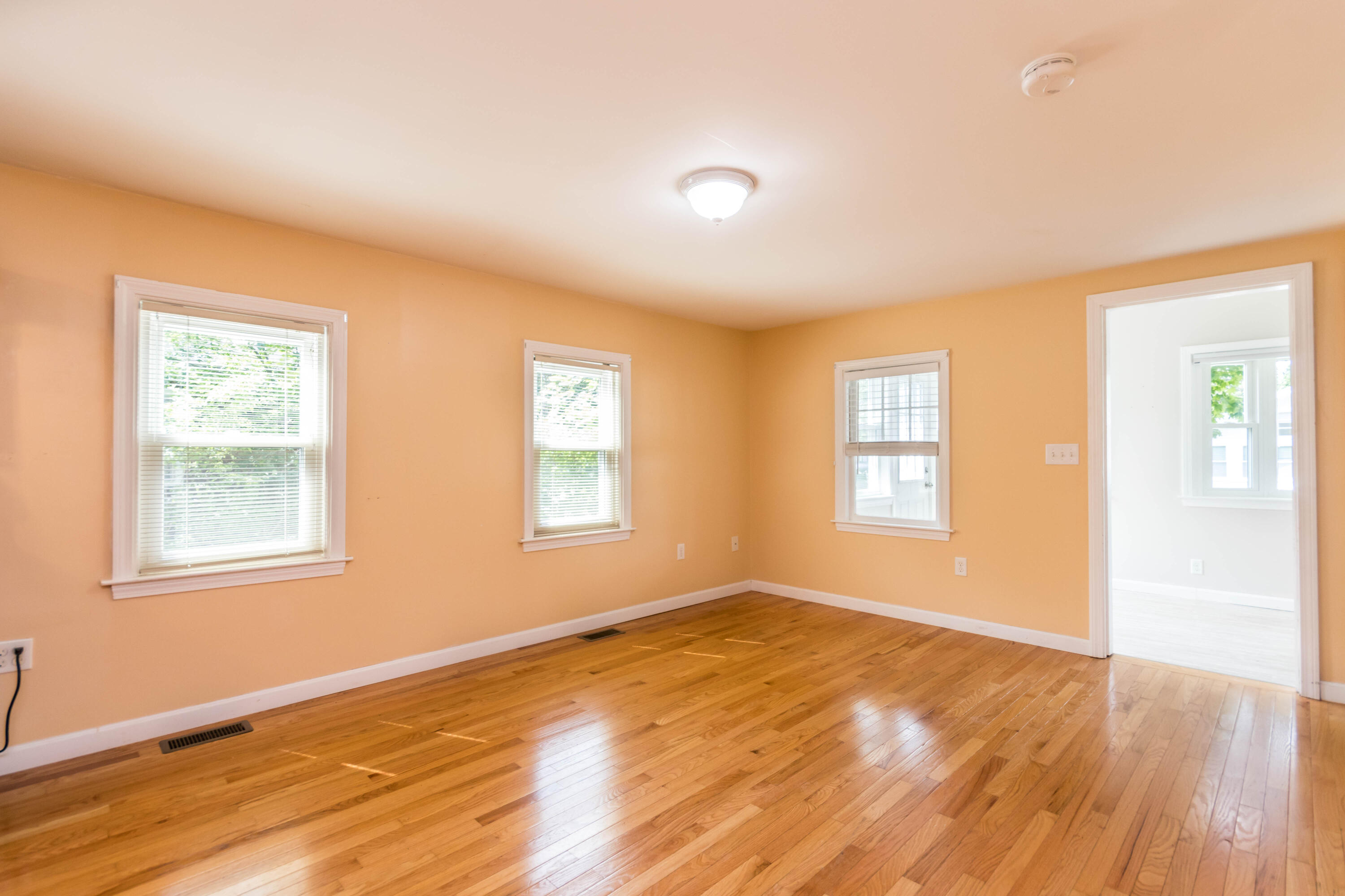 19 Monack Road Wareham, MA 02532 - Photo 6 of 24 an empty room with wooden floor and windows