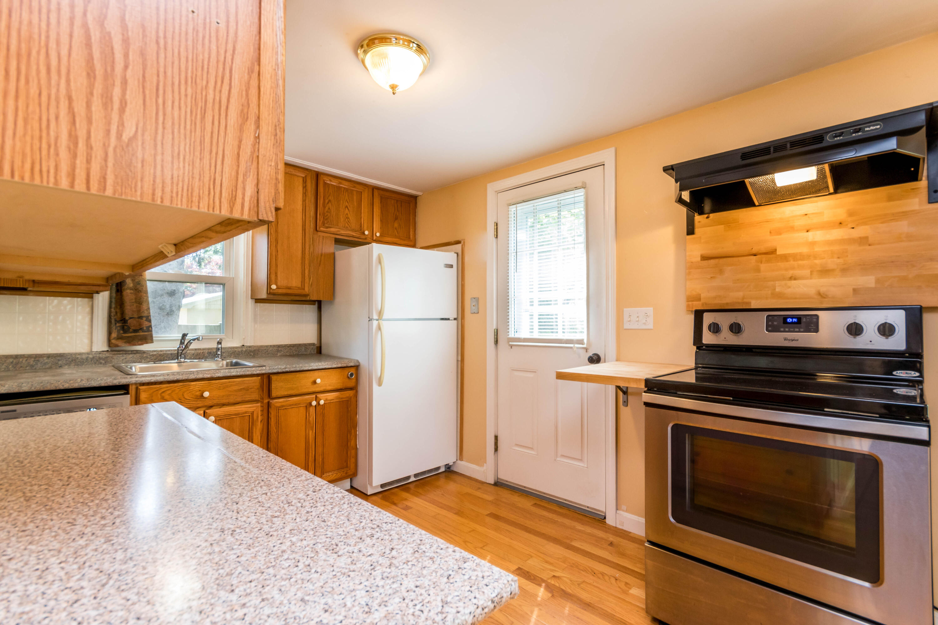 19 Monack Road Wareham, MA 02532 - Photo 8 of 24 a kitchen with stainless steel appliances granite countertop a refrigerator a stove and a sink with wooden floor