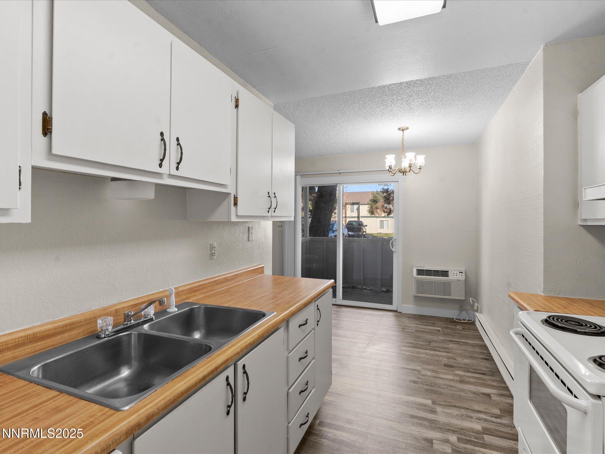 3935 Clear Acre Lane, Unit 215 Reno, NV 89512 - Photo 11 of 31 a kitchen with stainless steel appliances granite countertop a sink and a refrigerator