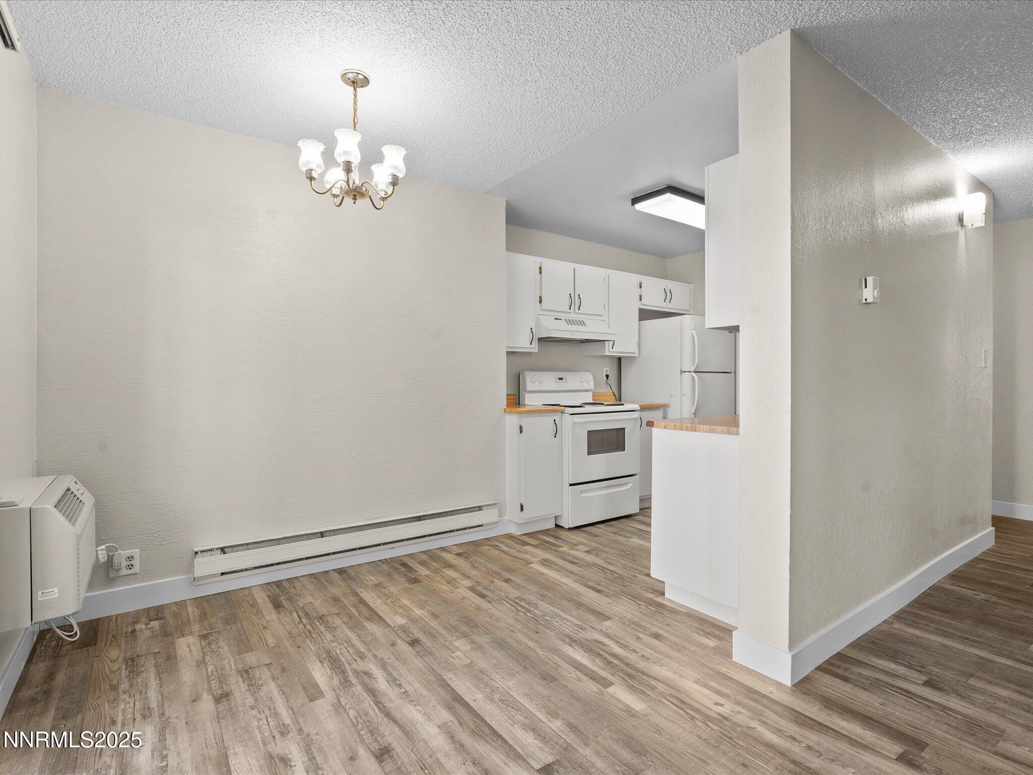 3935 Clear Acre Lane, Unit 215 Reno, NV 89512 - Photo 13 of 31 a view of empty room with wooden floor