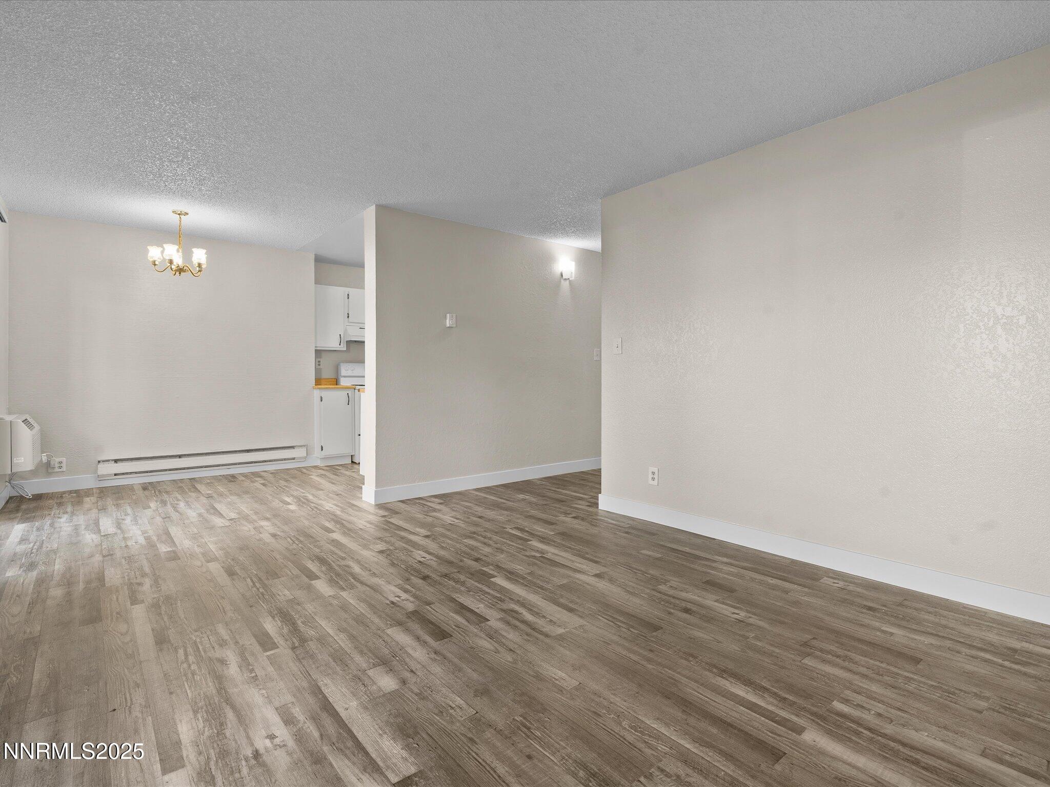 3935 Clear Acre Lane, Unit 215 Reno, NV 89512 - Photo 18 of 31 a view of an empty room and wooden floor