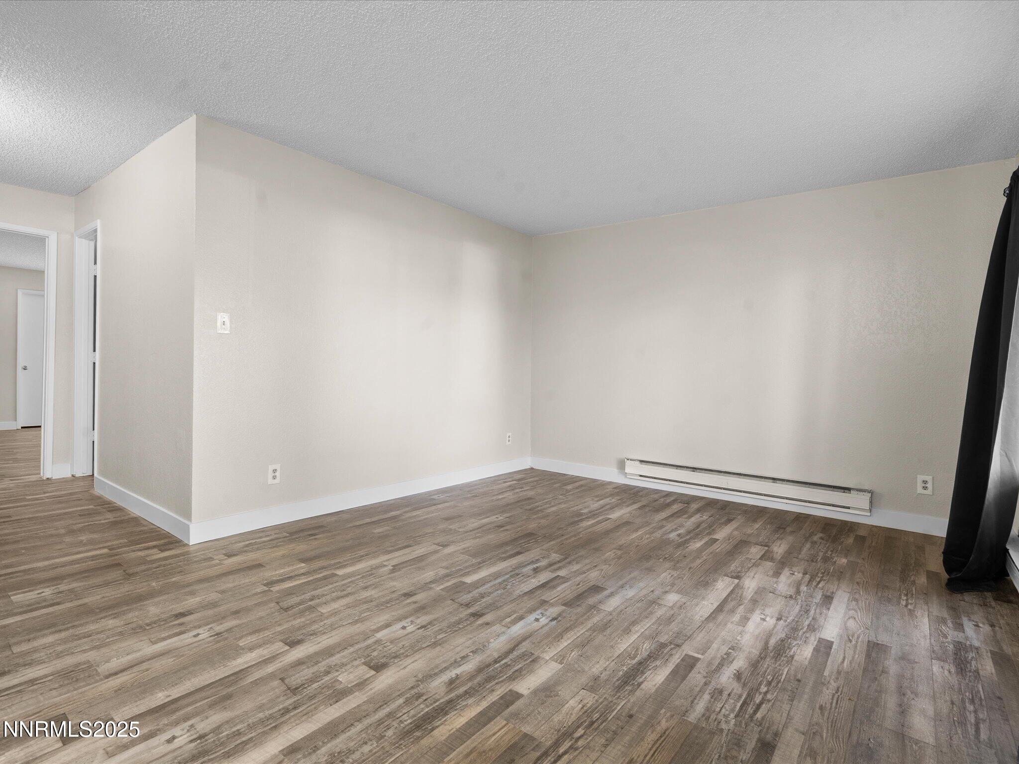 3935 Clear Acre Lane, Unit 215 Reno, NV 89512 - Photo 19 of 31 a view of an empty room and wooden floor