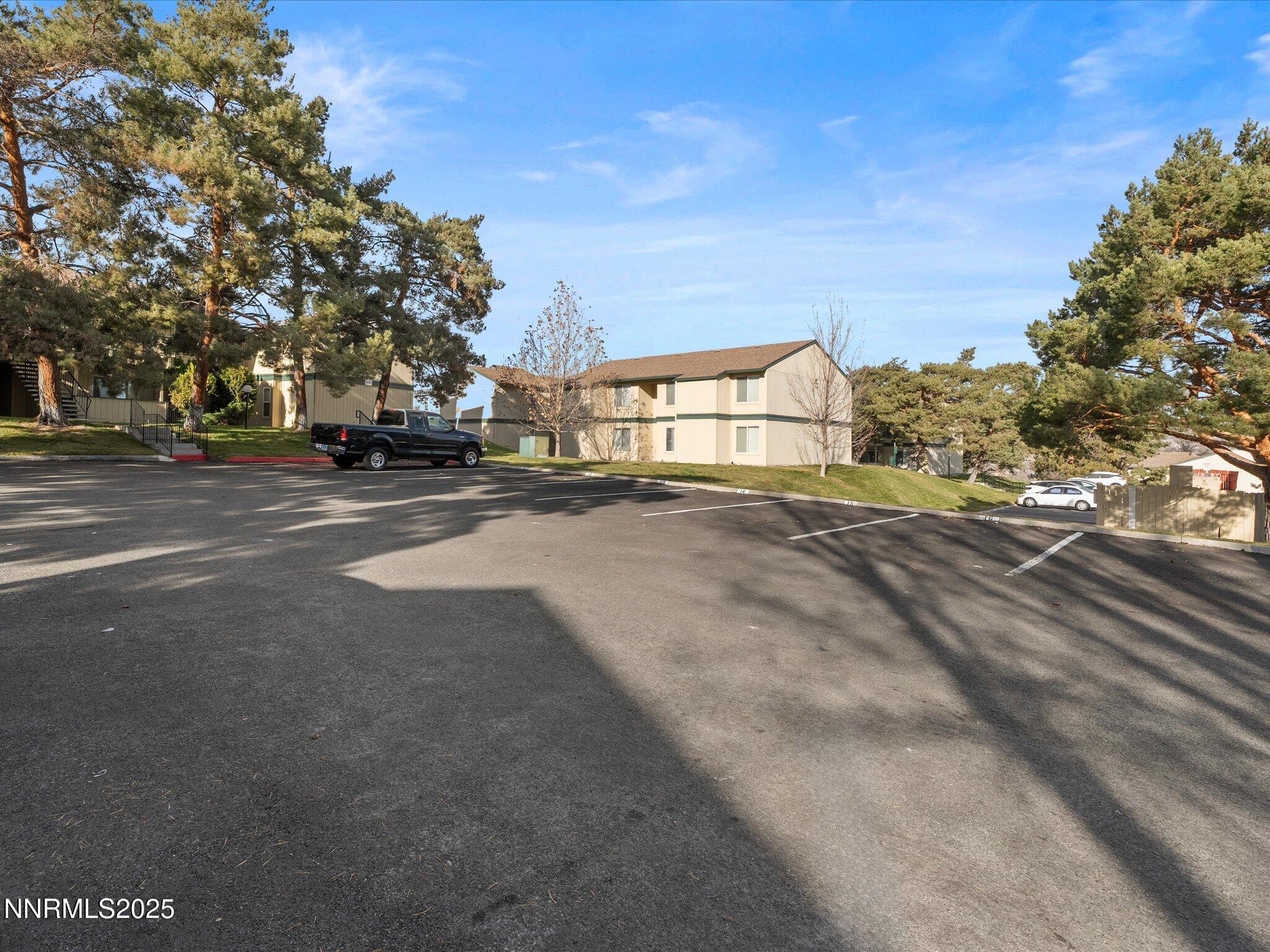 3935 Clear Acre Lane, Unit 215 Reno, NV 89512 - Photo 2 of 31 a view of road with large trees