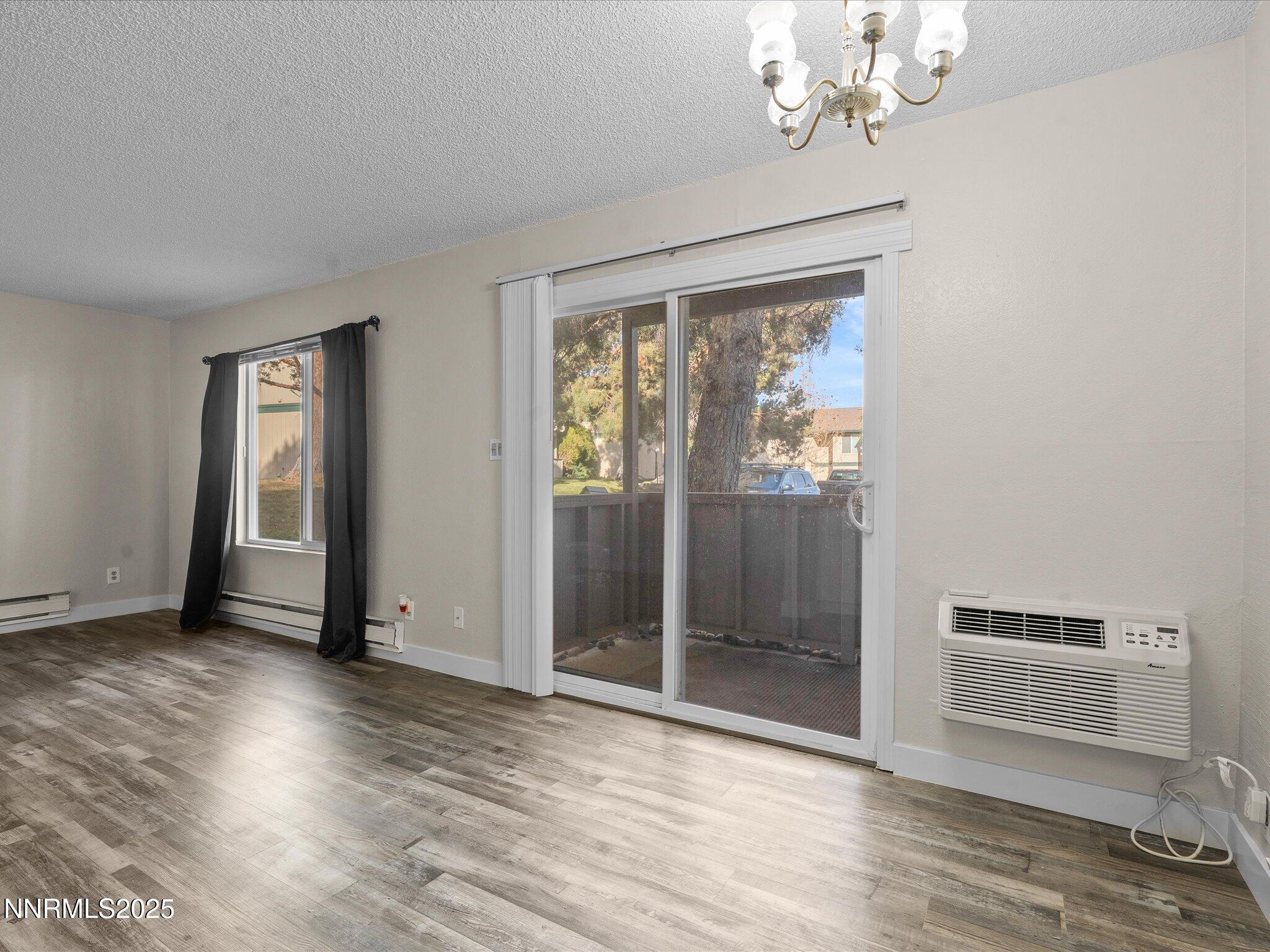 3935 Clear Acre Lane, Unit 215 Reno, NV 89512 - Photo 21 of 31 wooden floor in an empty room with a window
