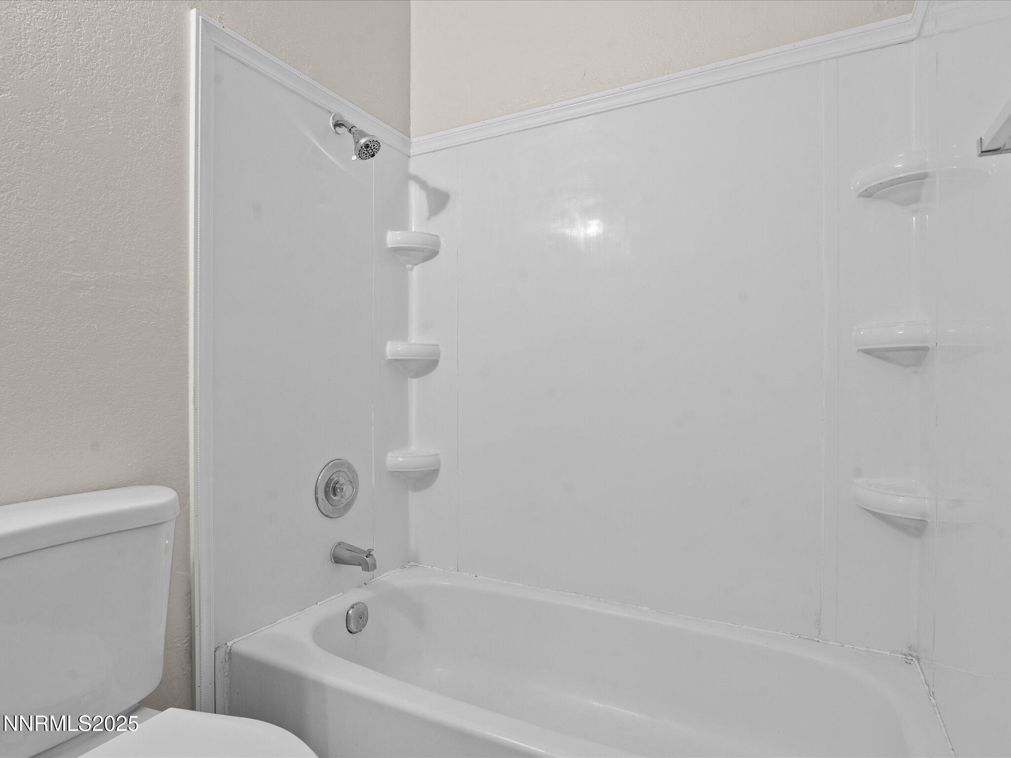 3935 Clear Acre Lane, Unit 215 Reno, NV 89512 - Photo 26 of 31 a bathroom with a bathtub and a toilet