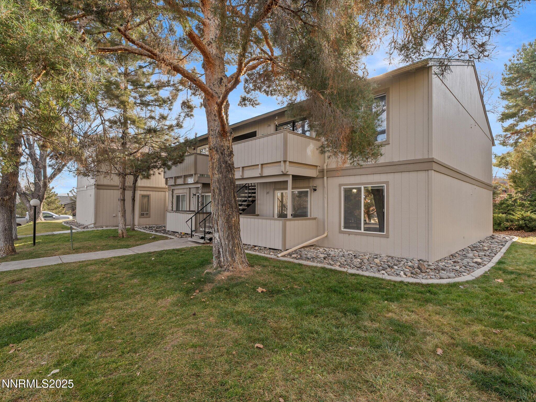 3935 Clear Acre Lane, Unit 215 Reno, NV 89512 - Photo 5 of 31 a white house that has tree in front of it