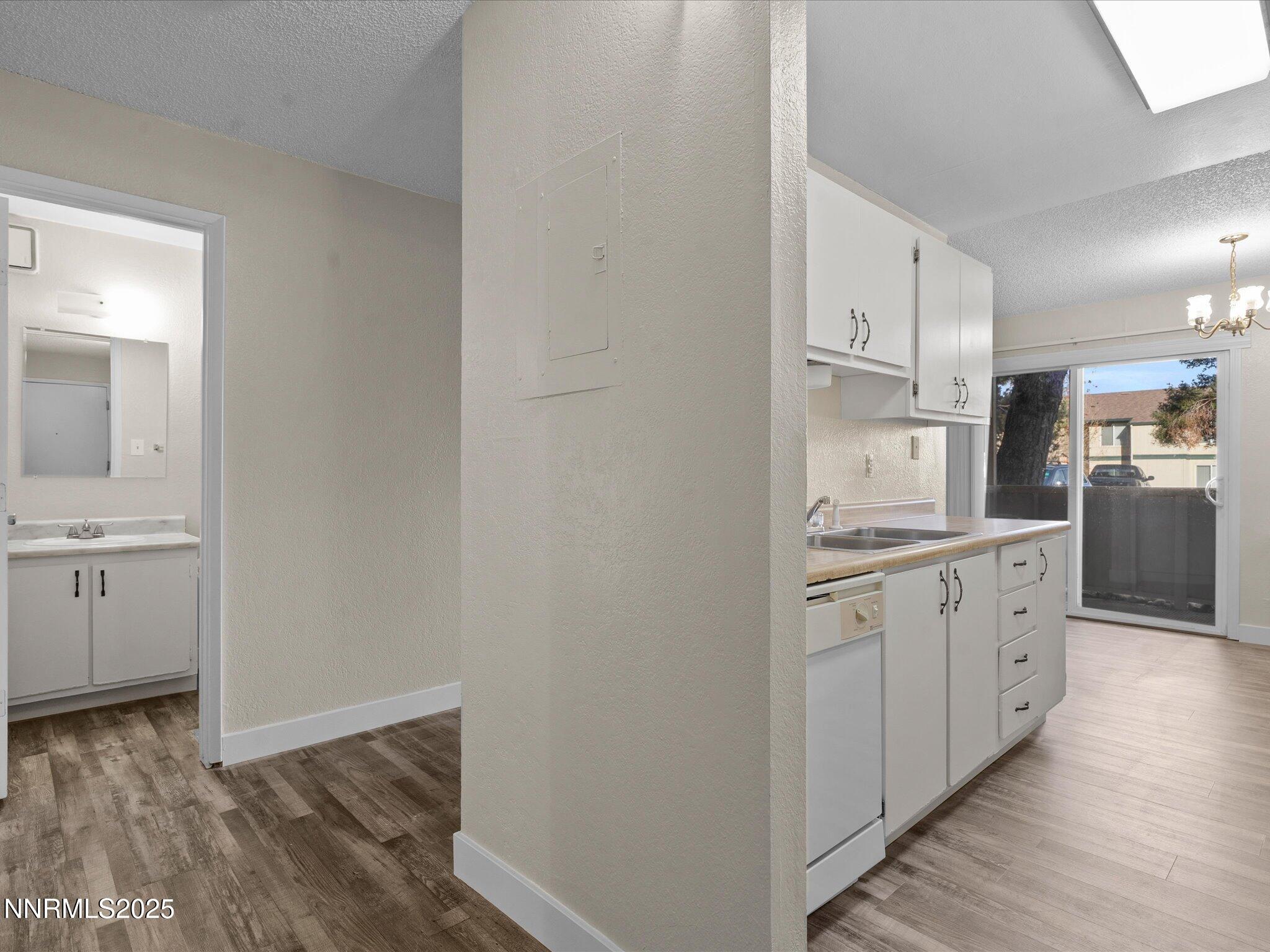 3935 Clear Acre Lane, Unit 215 Reno, NV 89512 - Photo 7 of 31 a kitchen with cabinets and wooden floor
