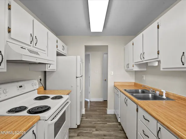 a kitchen with white cabinets and white appliances