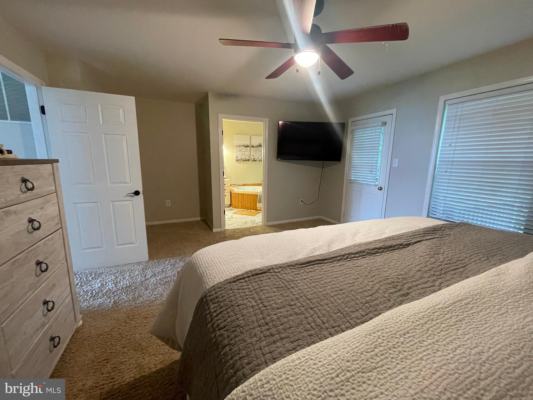 2315 Lookout Road Haymarket, VA 20169 - Photo 18 of 36 a bedroom with a large bed a flat tv screen and dresser