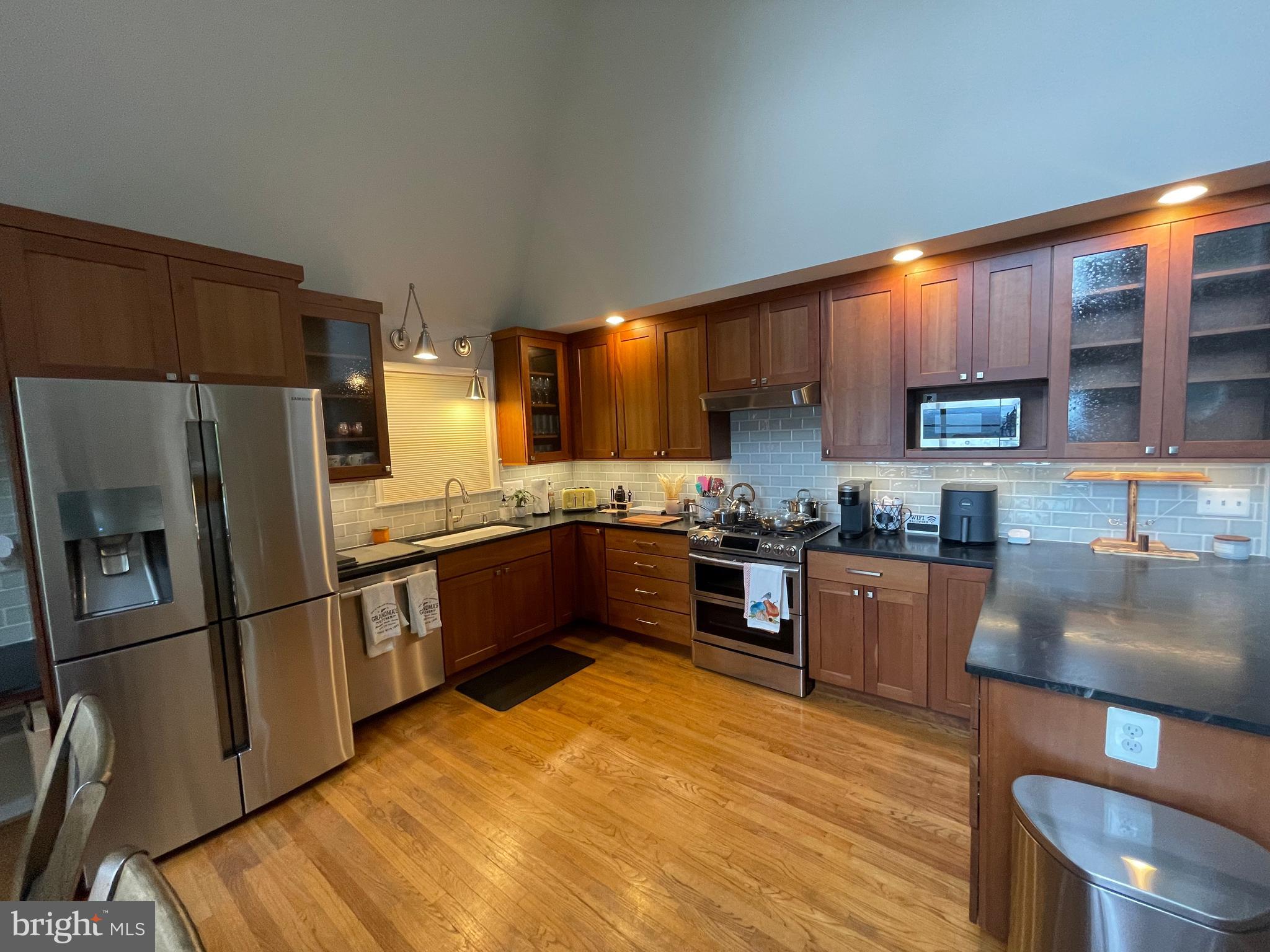 2315 Lookout Road Haymarket, VA 20169 - Photo 9 of 36 a kitchen with stainless steel appliances kitchen island granite countertop a refrigerator stove top oven and sink