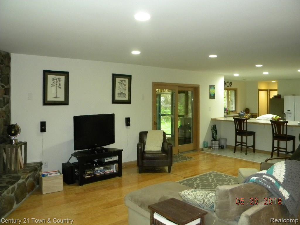 299 North Baldwin Road Oxford, MI 48371 - Photo 33 of 33 OPEN FLOOR PLAN, VIEW TO SCREENED COVERED PORCH AND OPEN KITCHEN W/ BAR TO SIT AT