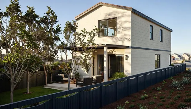 a kitchen with stainless steel appliances granite countertop a refrigerator a sink a stove a dining table and chairs