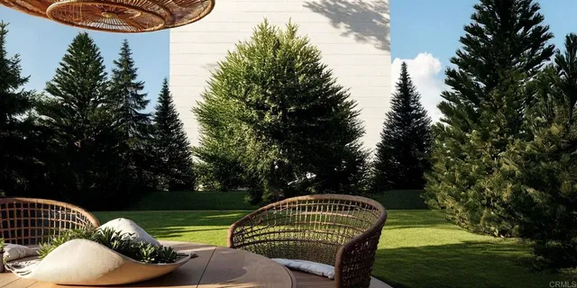 a view of a chairs and table in patio with wooden floor