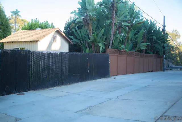 a view of a street with cars parked
