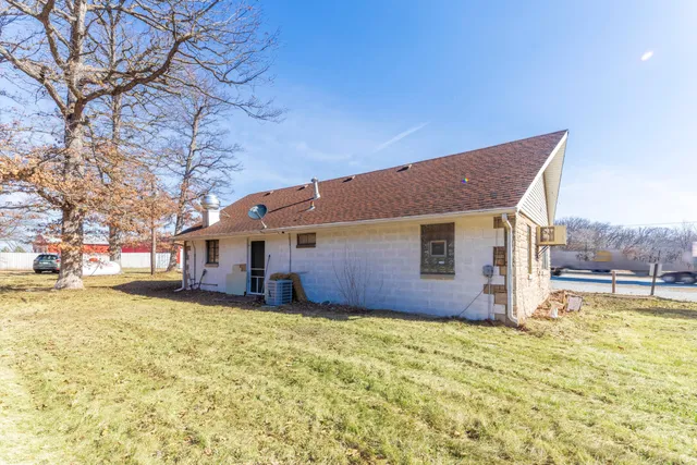 a view of a house with snow on the side of the road