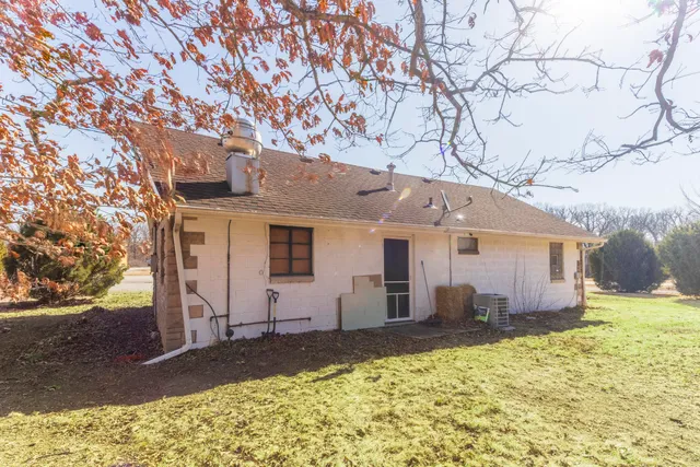 a view of a house with a yard garage and tree