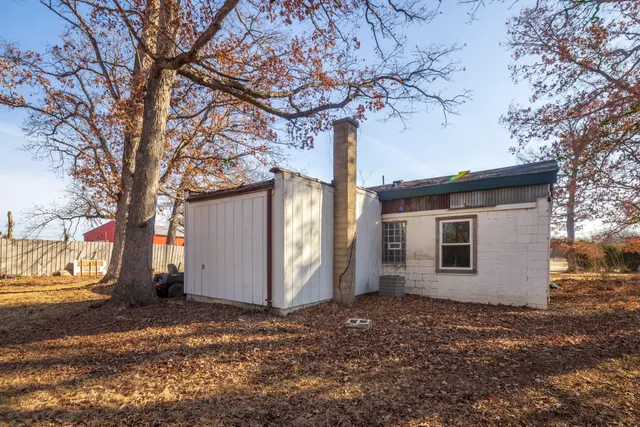an aerial view of a house with a yard and lake view