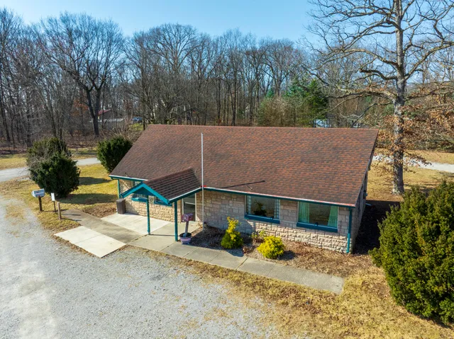 a view of a house with a yard and sitting area