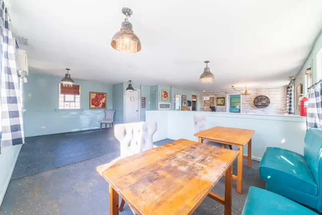 a dining room with a table and chairs