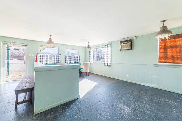 a kitchen that has a fridge and a window in it