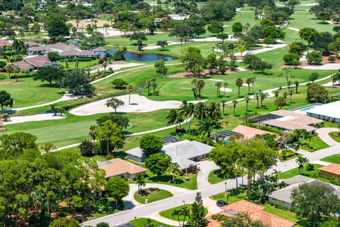 an aerial view of residential houses with outdoor space and street view